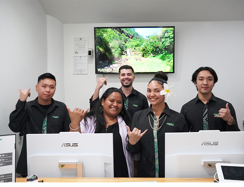 Friendly staff at First Rent A Car Hawaii office in Waikiki assisting customers