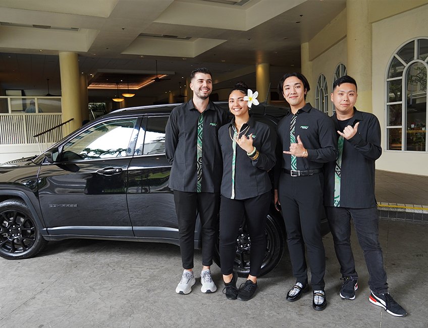 First Rent A Car Hawaii staff posing with a rental vehicle in Waikiki